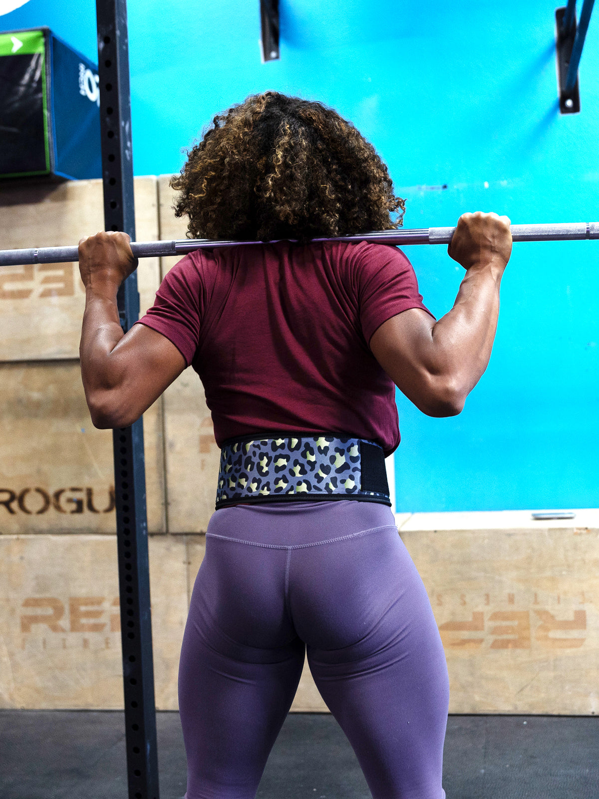 Woman lifting in leopard print lifting belt