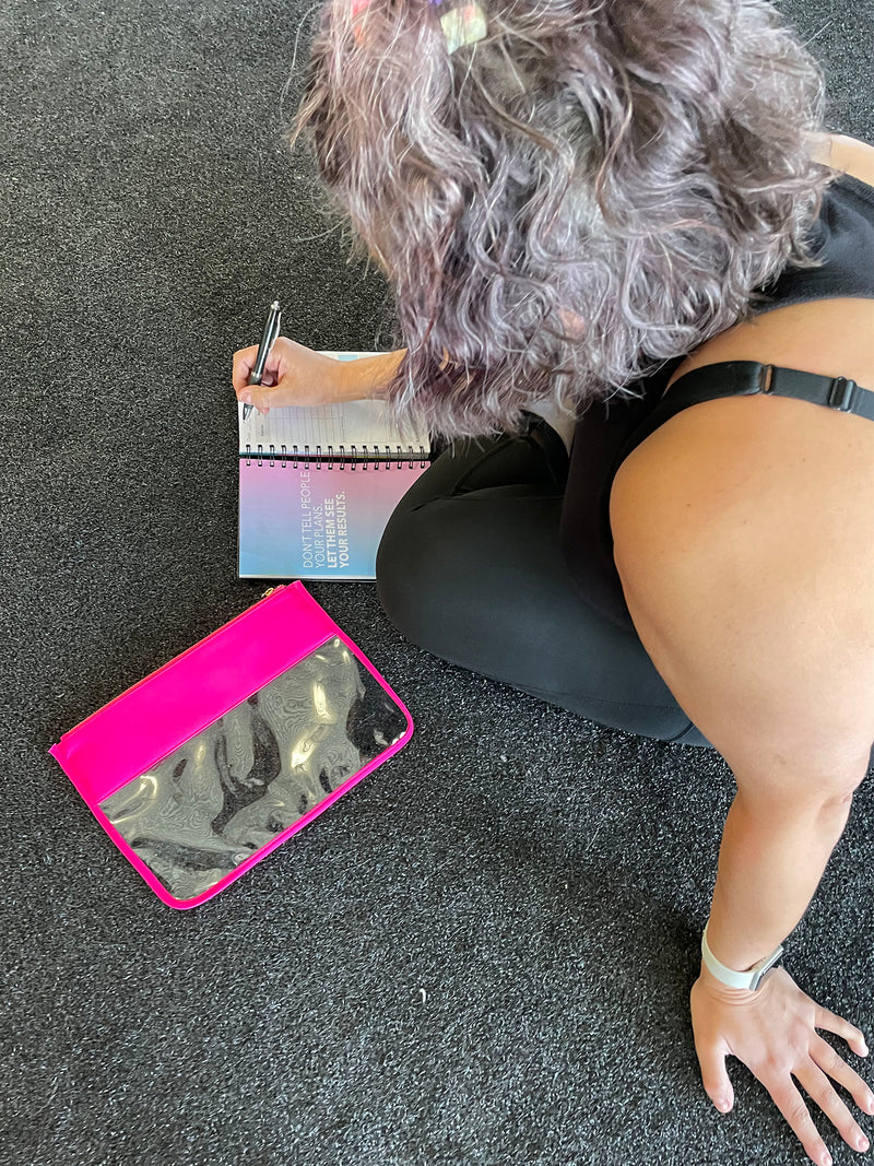 Woman writing in Fitness Journal
